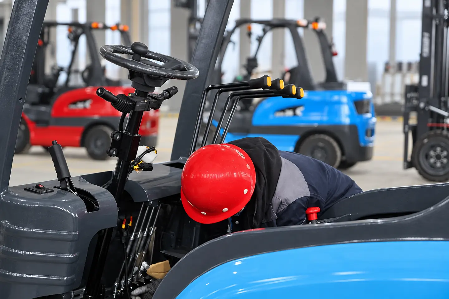 Technician working inside the operator area during forklift assembly