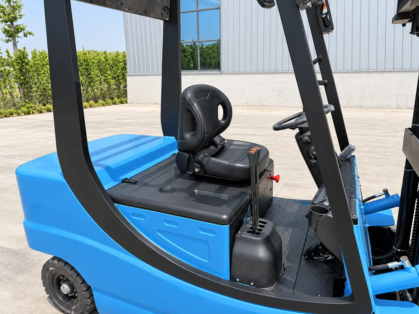 LETENG blue forklift operator area showing seat, steering and hydraulic levers